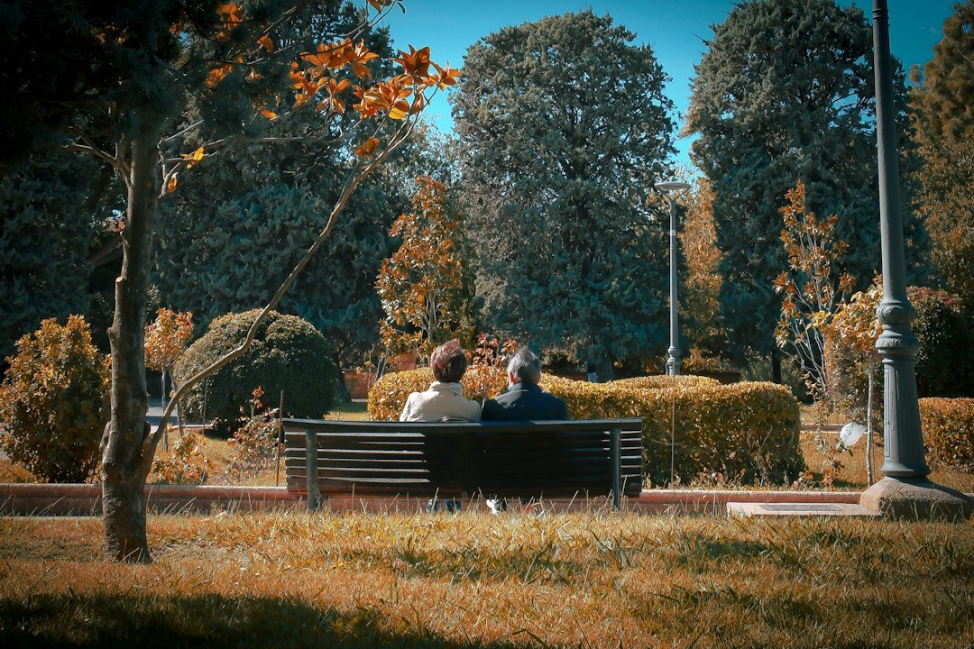 Two adults sitting together and having a calm conversation outdoors