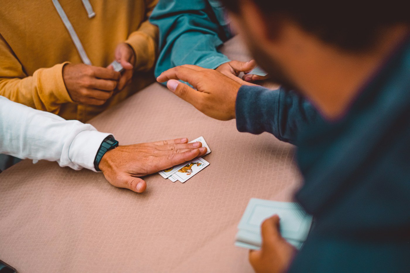 Friends playing cards at a table
