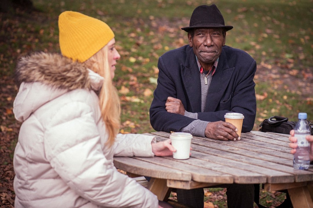 Two adults having a thoughtful conversation over coffee