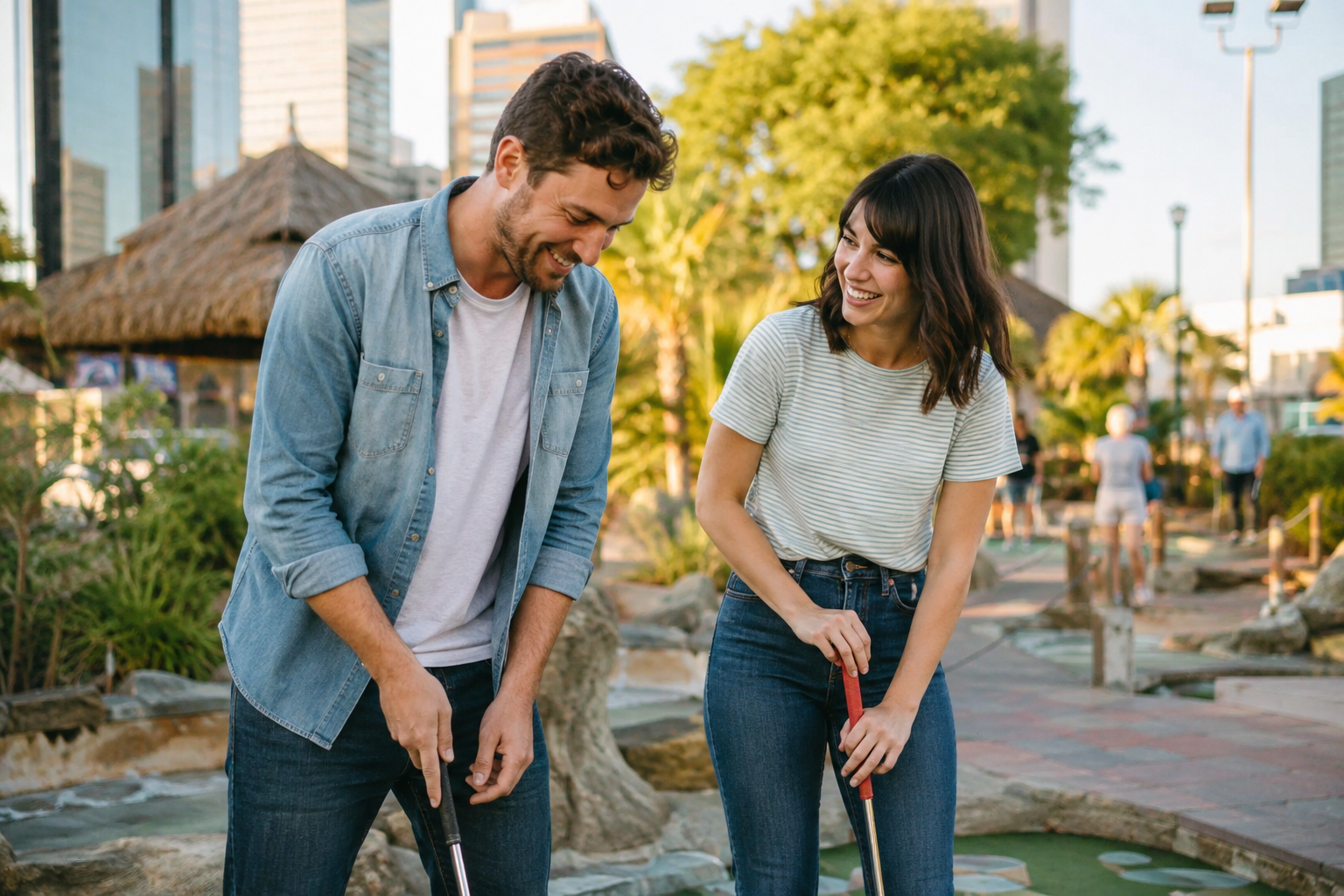 Two adults enjoying a casual mini golf activity in a public venue
