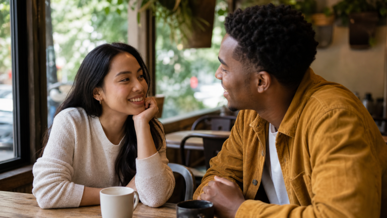 A couple talking warmly in a café, illustrating a healthy relationship